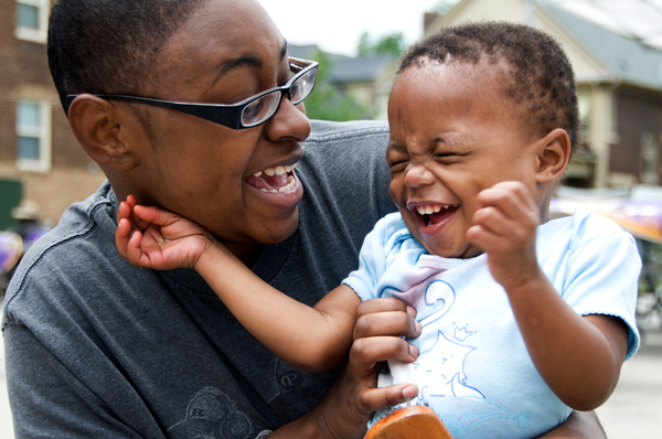 Mother with her toddler child laughing