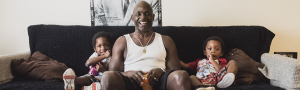 Anthony, Richmond Place Client, sits with his twin sons