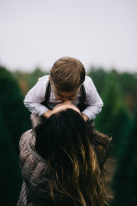 Mom holding Child in forest