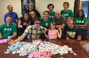 AWS Elemental volunteers and family sorting sugar packets for AKA Science